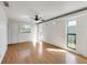 Living room featuring wood floors, ceiling fan, and natural light from two windows at 1137 54Th S Ave, St Petersburg, FL 33705