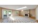 Living room with a stone fireplace, a skylight, and access to the patio at 1137 54Th S Ave, St Petersburg, FL 33705