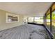 Covered screened patio with wood flooring, offering a relaxing outdoor space at 1137 54Th S Ave, St Petersburg, FL 33705