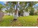 Spacious backyard featuring a covered patio and well-maintained lawn at 1489 Ridge Shore Dr, Tarpon Springs, FL 34689