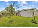 Lush backyard with green grass and mature trees at 1489 Ridge Shore Dr, Tarpon Springs, FL 34689