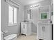Bathroom featuring gray walls, double sink vanity, and a large window at 1489 Ridge Shore Dr, Tarpon Springs, FL 34689