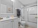 Bright bathroom with white fixtures and a glass-enclosed shower at 1489 Ridge Shore Dr, Tarpon Springs, FL 34689