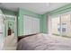 Bedroom with sliding glass door and neutral green walls at 1489 Ridge Shore Dr, Tarpon Springs, FL 34689