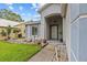 Inviting front entrance with an arched porch and tiled walkway through the garden at 1489 Ridge Shore Dr, Tarpon Springs, FL 34689