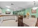 Open kitchen area with tile floor, white cabinets and stainless steel appliances at 1489 Ridge Shore Dr, Tarpon Springs, FL 34689