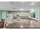 Bright kitchen showcases white cabinets, granite countertops, and stainless steel appliances at 1489 Ridge Shore Dr, Tarpon Springs, FL 34689
