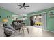 Bright living room with tile floors, ceiling fan, and sliding glass doors to the backyard at 1489 Ridge Shore Dr, Tarpon Springs, FL 34689