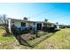 Cozy backyard featuring black metal fence, well-maintained lawn, and a glimpse of a sunroom at 1503 Council Dr, Sun City Center, FL 33573