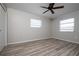 Clean, freshly painted bedroom with wood-look floors, and a ceiling fan at 1503 Council Dr, Sun City Center, FL 33573