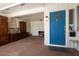 Entryway featuring a bright blue door and vintage furniture at 1503 Council Dr, Sun City Center, FL 33573