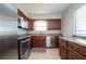 Contemporary kitchen featuring stainless steel appliances, granite countertops, and a window at 1503 Council Dr, Sun City Center, FL 33573