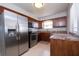 Modern kitchen with stainless steel appliances, granite countertops, and wooden cabinetry at 1503 Council Dr, Sun City Center, FL 33573