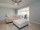 Bright living room with tile flooring, a comfortable sofa, and open access to the sunroom at 1503 Council Dr, Sun City Center, FL 33573