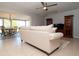 Spacious living room with a comfortable sofa, ceiling fan, and adjacent dining area at 1503 Council Dr, Sun City Center, FL 33573