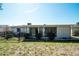 Back of house with a sunroom that is surrounded by green bushes at 1503 Council Dr, Sun City Center, FL 33573