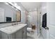 Stylish bathroom with a marble vanity and a glass-enclosed shower at 1719 Belleair Forest Dr # B, Belleair, FL 33756