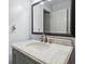 Close-up of a bathroom with a marble vanity and modern fixtures at 1719 Belleair Forest Dr # B, Belleair, FL 33756