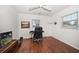 Bright bedroom featuring modern ceiling fan, windows, and wood flooring at 1719 Belleair Forest Dr # B, Belleair, FL 33756