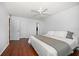 Cozy bedroom with wood floors, neutral decor, and a comfortable bed at 1719 Belleair Forest Dr # B, Belleair, FL 33756