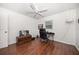 Another bedroom featuring wood floors, ceiling fan and simple decor at 1719 Belleair Forest Dr # B, Belleair, FL 33756