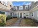 Well-kept condo with a gambrel roof, charming green door, and freshly landscaped walkway at 1719 Belleair Forest Dr # B, Belleair, FL 33756