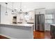 Modern kitchen featuring white cabinets, stainless steel appliances, sleek countertops, and a stylish subway tile backsplash at 1719 Belleair Forest Dr # B, Belleair, FL 33756