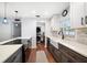 Bright kitchen with modern appliances, white countertops, and a farmhouse sink at 1719 Belleair Forest Dr # B, Belleair, FL 33756