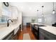 Modern kitchen with an island featuring white countertops, stainless steel appliances, and hardwood floors, great for entertaining at 1719 Belleair Forest Dr # B, Belleair, FL 33756