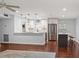 Bright, modern kitchen with white cabinetry, stainless steel appliances, and a functional island for meal preparation at 1719 Belleair Forest Dr # B, Belleair, FL 33756