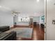 Open-concept living room flowing into kitchen, with hardwood floors and modern decor at 1719 Belleair Forest Dr # B, Belleair, FL 33756