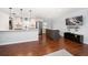 Open-concept living area with hardwood flooring, a kitchen island, and stainless steel appliances for modern living at 1719 Belleair Forest Dr # B, Belleair, FL 33756