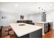 Spacious living room flows into a modern kitchen with white countertops, hardwood floors, and stainless steel appliances at 1719 Belleair Forest Dr # B, Belleair, FL 33756