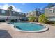 Bright community pool with ample seating, surrounded by well-maintained condos and lush landscaping at 1719 Belleair Forest Dr # B, Belleair, FL 33756