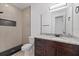 Modern bathroom featuring a granite countertop, dark wood cabinets, and a tiled shower at 1910 W North A St # 5, Tampa, FL 33606