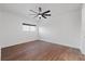 Bright bedroom with wood floors, a ceiling fan, and a window offering natural light at 1910 W North A St # 5, Tampa, FL 33606