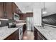 Modern kitchen with stainless steel appliances, granite countertops, and dark wood cabinetry at 1910 W North A St # 5, Tampa, FL 33606