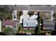 Aerial view of home featuring a well-manicured front yard, backyard entertainment area, and a private dock at 201 79Th Ne Ave, St Petersburg, FL 33702