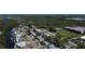 Wide aerial view of a neighborhood adjacent to a waterway and a recreational area with mature tree coverage at 201 79Th Ne Ave, St Petersburg, FL 33702