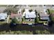 Scenic aerial view of a home near the water, complemented by mature trees and meticulous landscaping at 201 79Th Ne Ave, St Petersburg, FL 33702