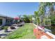 The backyard presents a canal view, a patio with a fire pit, and a dining set on a wood deck at 201 79Th Ne Ave, St Petersburg, FL 33702