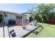 Backyard with a charming patio, colorful seating, and lush tropical landscaping at 201 79Th Ne Ave, St Petersburg, FL 33702