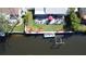 Beautiful backyard with a waterfront view featuring a boat dock, patio area, and inviting outdoor seating at 201 79Th Ne Ave, St Petersburg, FL 33702
