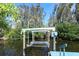 A close up image of the boat lift system with lush greenery and waterfront views at 201 79Th Ne Ave, St Petersburg, FL 33702