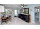 Bright dining area with unique barrel accents, seamlessly flowing into the bathroom and living space at 201 79Th Ne Ave, St Petersburg, FL 33702