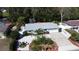 Aerial shot of home with a driveway, manicured front yard with palm trees, and waterfront in the back at 201 79Th Ne Ave, St Petersburg, FL 33702
