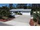 Beautiful single-story home with a two-car garage, lovely landscaping, and a concrete driveway at 201 79Th Ne Ave, St Petersburg, FL 33702