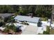 Home showing a manicured front yard with palm trees, paved driveway, and access to a waterway at 201 79Th Ne Ave, St Petersburg, FL 33702