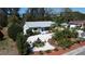 Charming single-story home featuring a decorative fountain, stone landscaping, and lush greenery at 201 79Th Ne Ave, St Petersburg, FL 33702