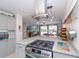 Kitchen featuring stainless steel appliances, stylish range hood, and an island with gas range at 201 79Th Ne Ave, St Petersburg, FL 33702